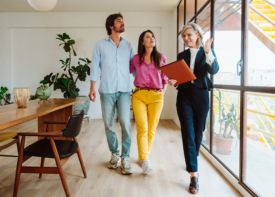 Couple touring a modern home with agent