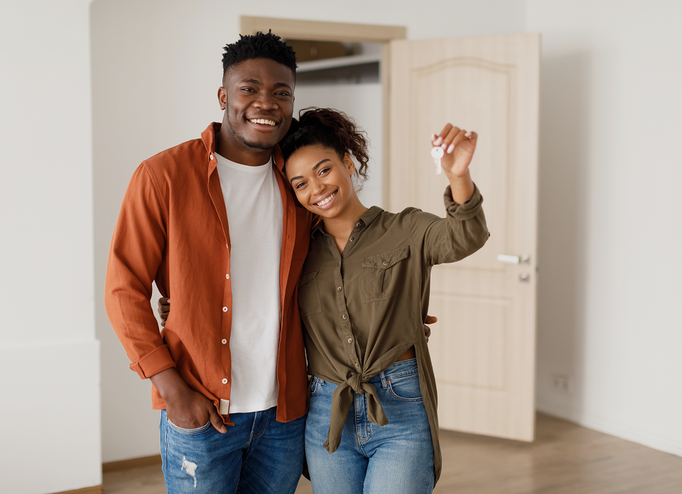 Smiling pair celebrating new apartment